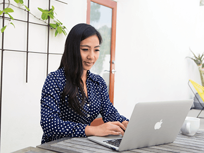 Woman in polka-dot shirt working on computer