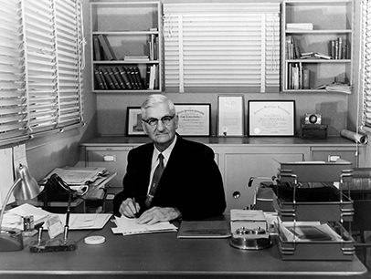 Toastmasters International founder Ralph C. Smedley sitting at his desk