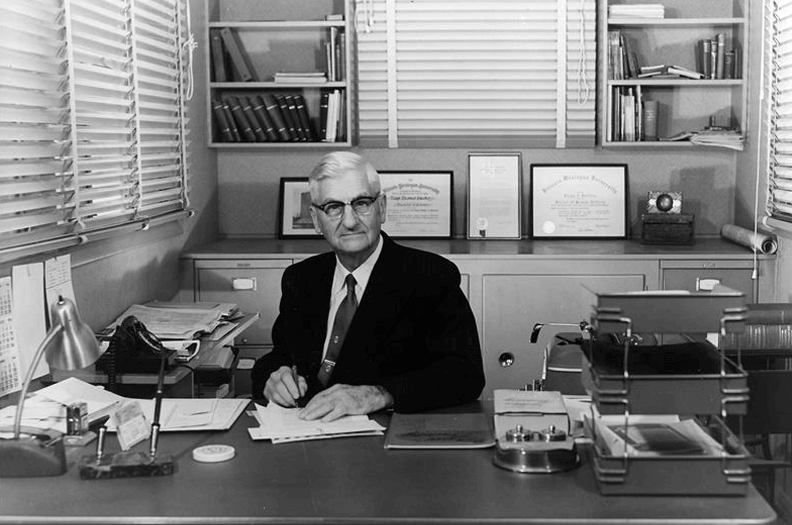 Toastmasters International founder Ralph C. Smedley sitting at his desk