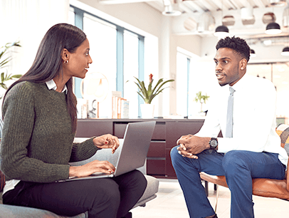 Man and woman sitting down talking during job interview  