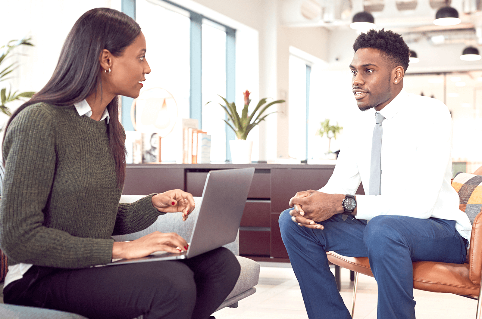 Man and woman sitting down talking during job interview