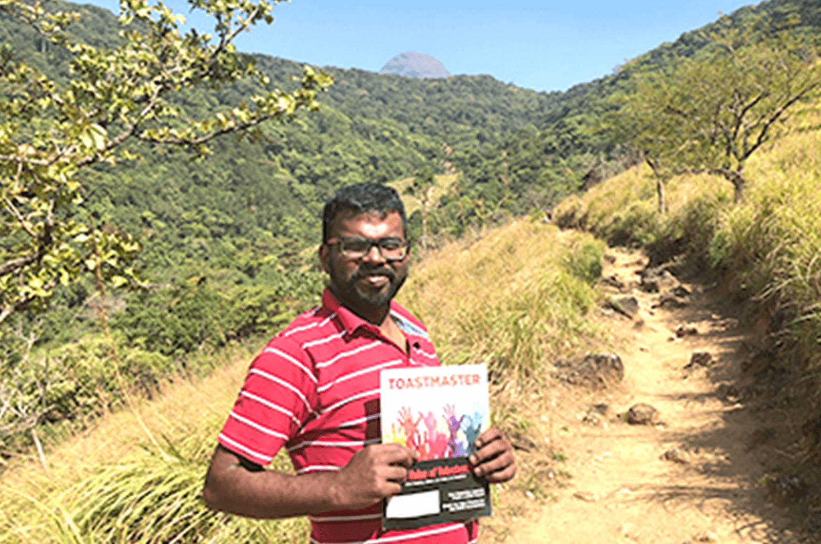 Pakshi Rajan M of Chennai, Tamil Nadu, India, treks with his magazine in the Pogthigai Hills on the border of Kerala and Tamil Nadu, India. The area is said to be where the sage Agastya created the grammar for the Tamil language.