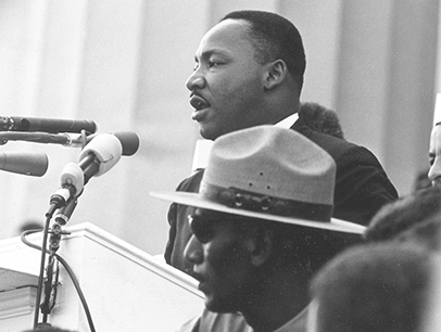 Martin Luther King Jr. speaking into microphone 