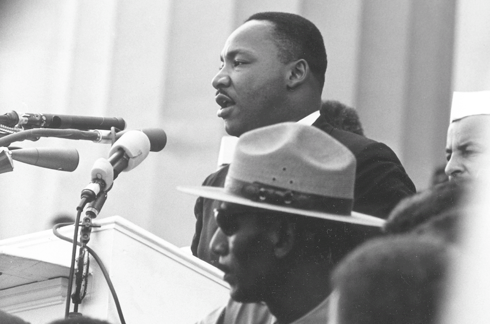 Martin Luther King Jr. speaking into microphone 