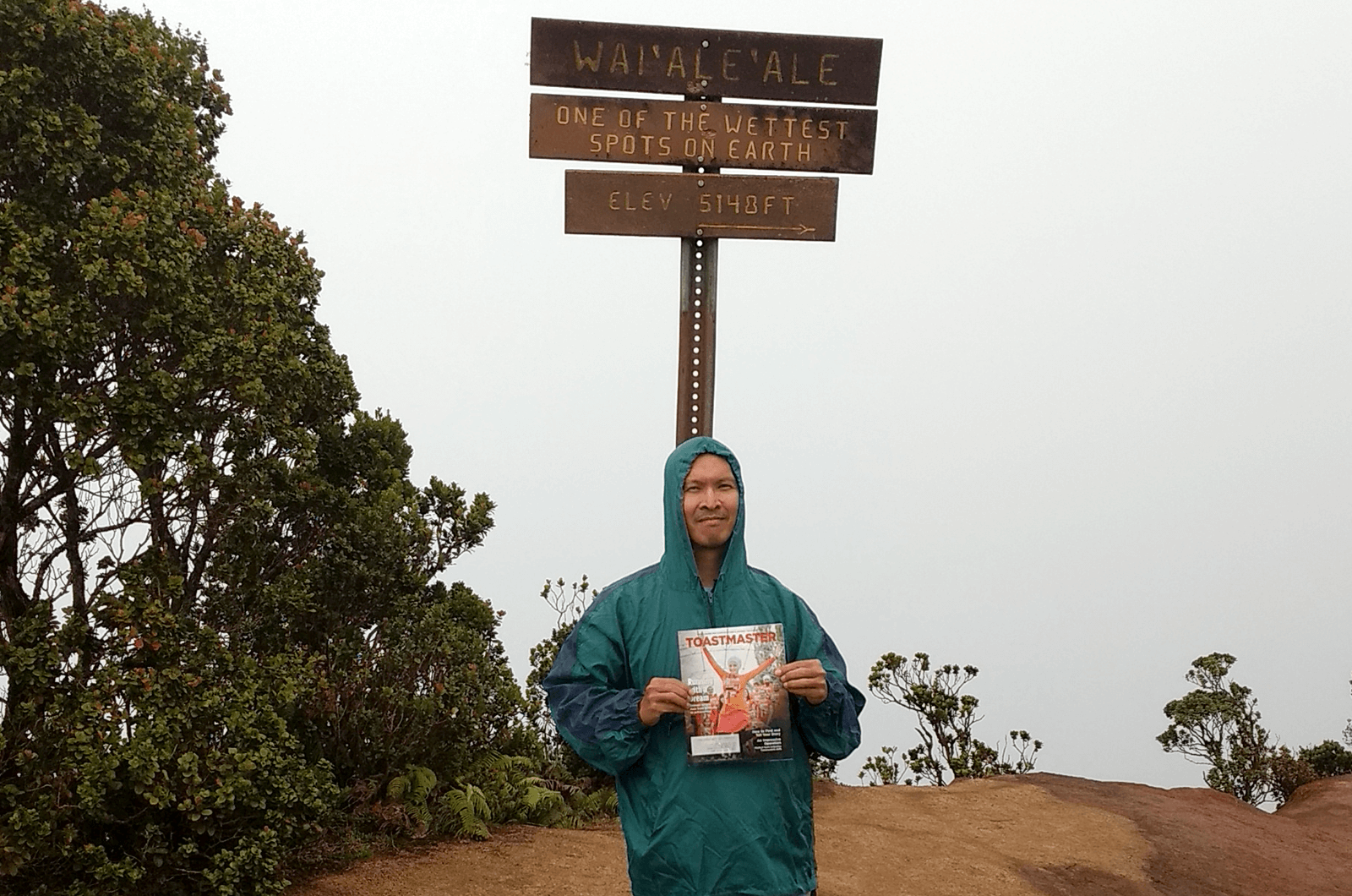 Hieu H. Huynh, DTM, of Royal Palm Beach, Florida, tries to stay dry at Mount Waialeale in Kauai, Hawaii, U.S. This shield volcano is the second-highest point on the island and the name means “rippling water.” It is one of the rainiest spots on earth.