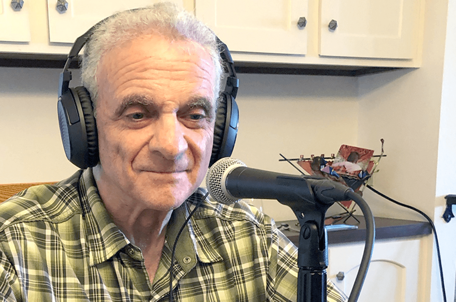 Man wearing headphones with microphone on table 