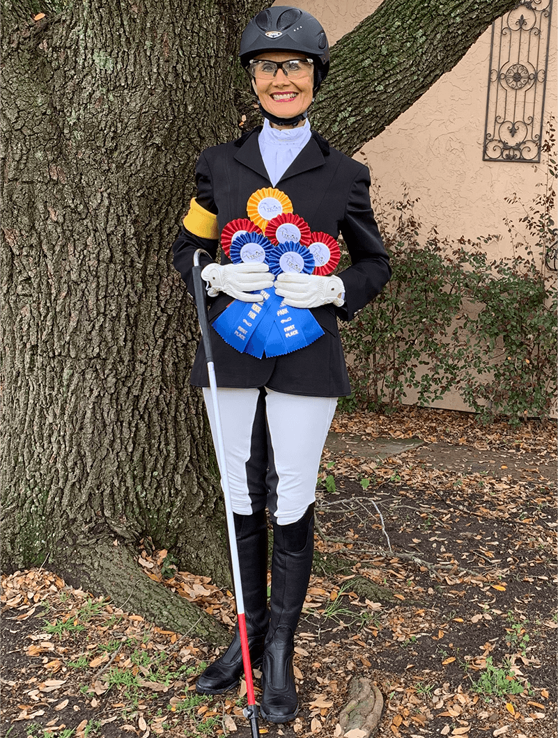 McAlexander smiles proudly with ribbons she won from the Texas Rose Dressage Classic.