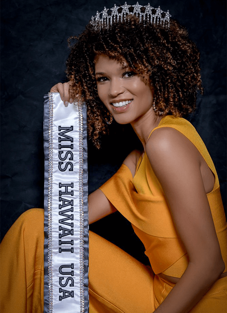 Neyland, posing with her sash and crown, first won Miss Hawaii Teen USA in 2013. At the suggestion of a pageant judge, she joined Toastmasters to improve her speaking and interviewing skills. Photo Credit: Brice Kurihara