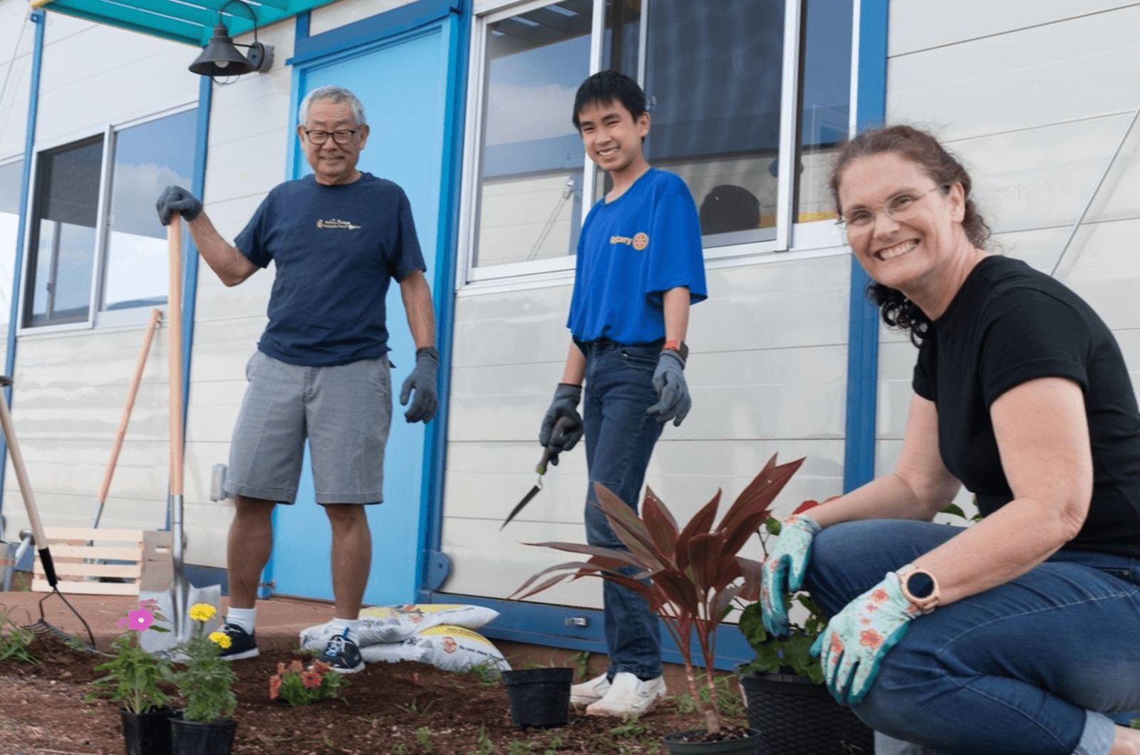 Three people working outside on garden project