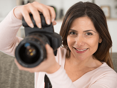 Woman holding up camera to take photo