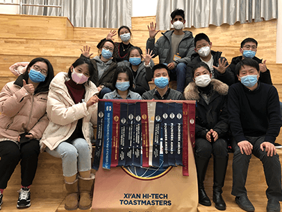 Group of people wearing masks and holding banner