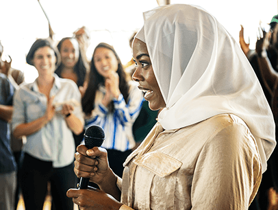 Woman wearing hijab holding microphone