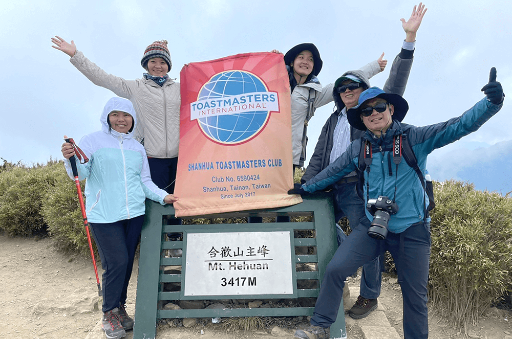 Shanhua Toastmasters members of Tainan, Taiwan, show their club support as they climb Mt. Hehuan, also called Joy Mountain, in the Taroko National Park.