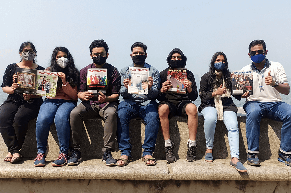 Members of the TCS Maitree Toastmasters Club of Mumbai, Maharashtra, India, attend a club meeting at Marine Drive—a long promenade that runs along the coast of a bay.