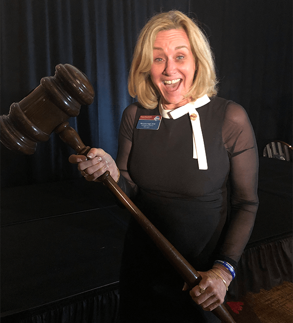 Page borrows a giant gavel from District 39 while campaigning for Second Vice President in 2018.