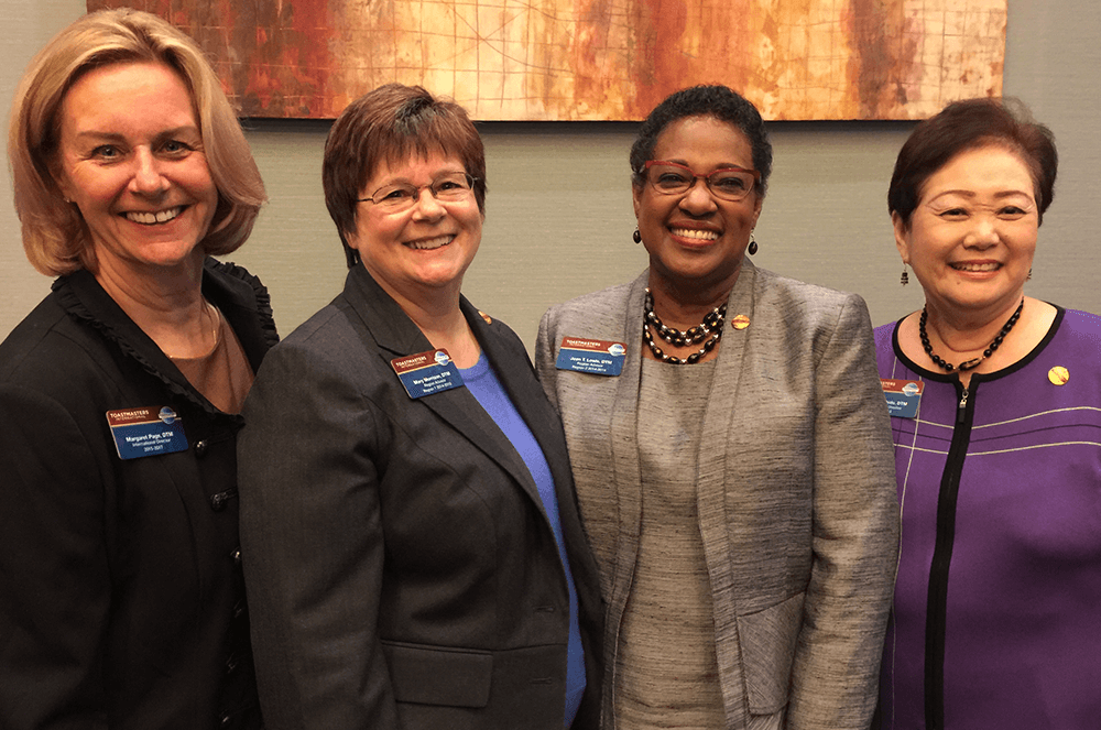 Page takes a picture with fellow members Mary Morrison, DTM, Joan T. Lewis, DTM, and Past International Director Gloria Shishido, DTM.