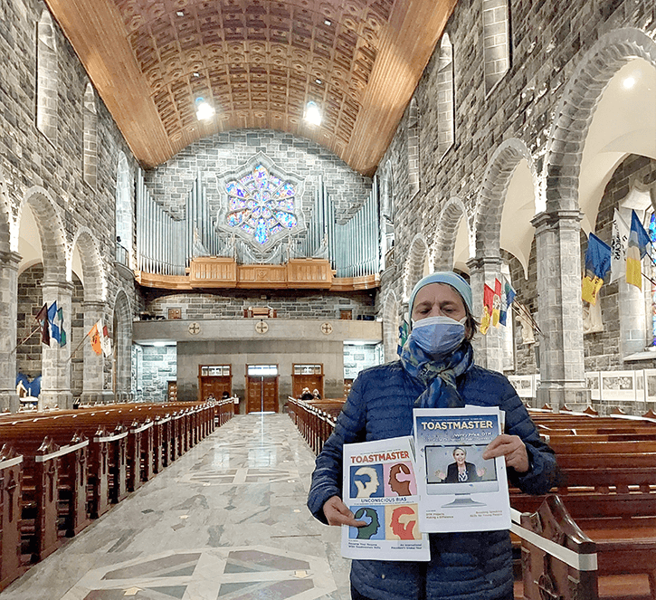 Britta Brunström of Turku, Finland, visits a cathedral in Galway, Ireland, with her printed out copies of the Toastmaster.