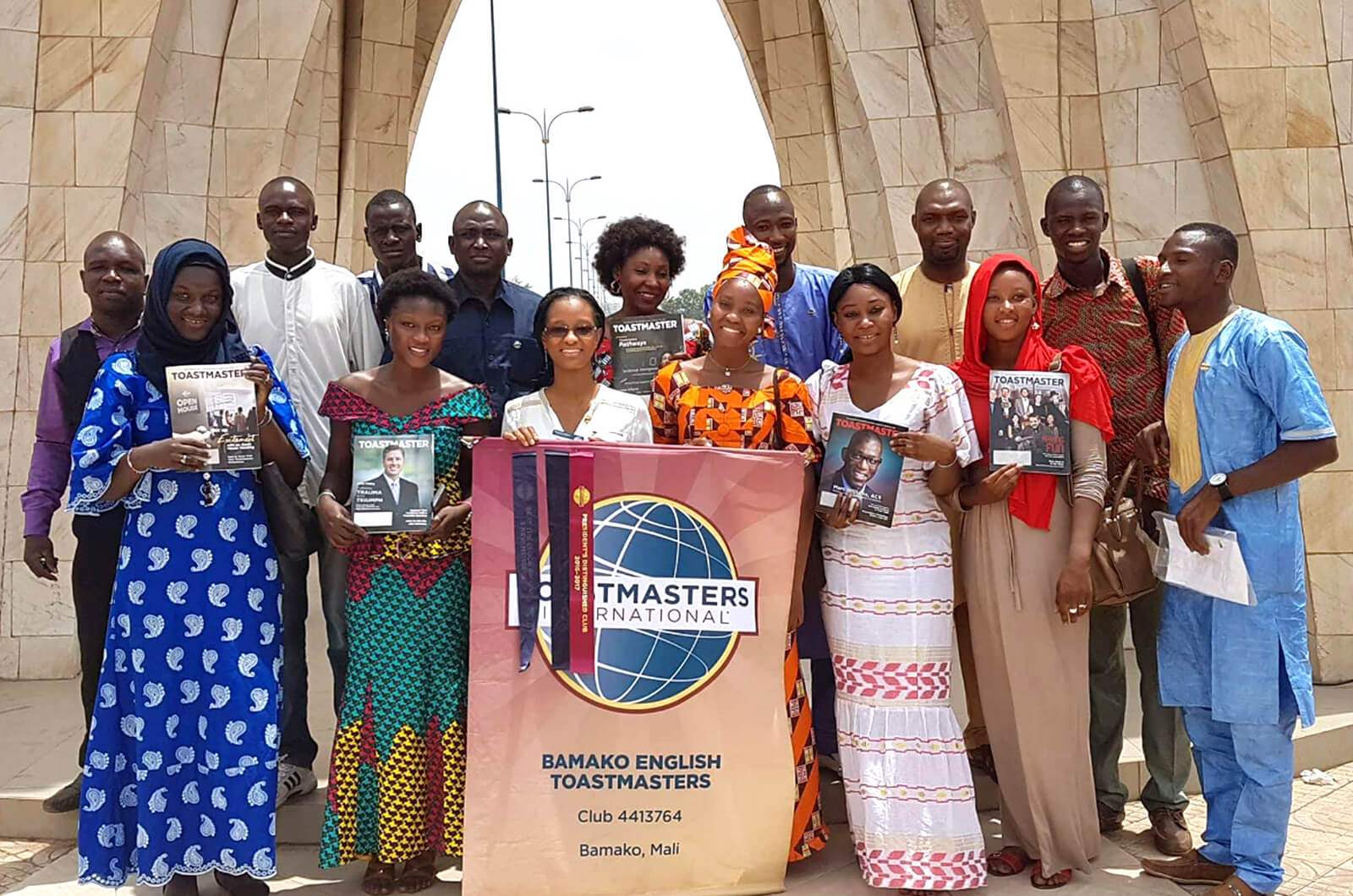 Bamako English Toastmasters club members gather under the Place de l'indépendance monument in Bamako, Mali.