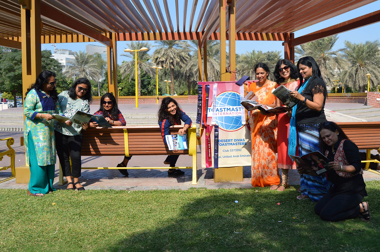 Members of the Desert Divas club of Dubai, United Arab Emirates, relax in the shade while hosting a meeting at a local park.