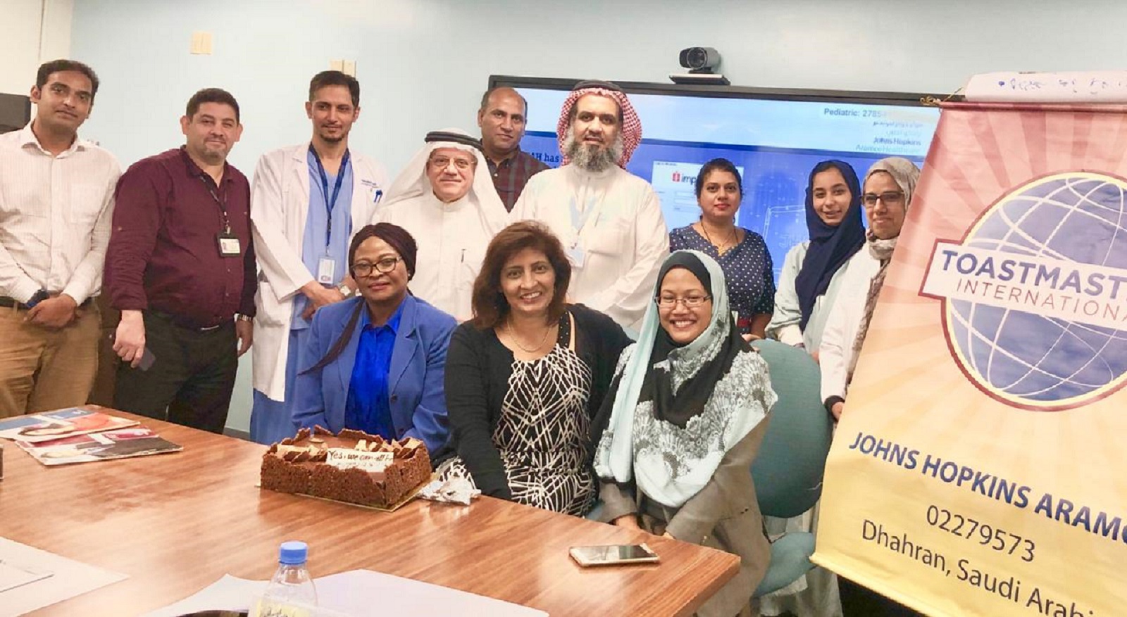 Members of the Johns Hopkins Aramco Healthcare club in Dhahran, Saudi Arabia, gather together for a club photo.